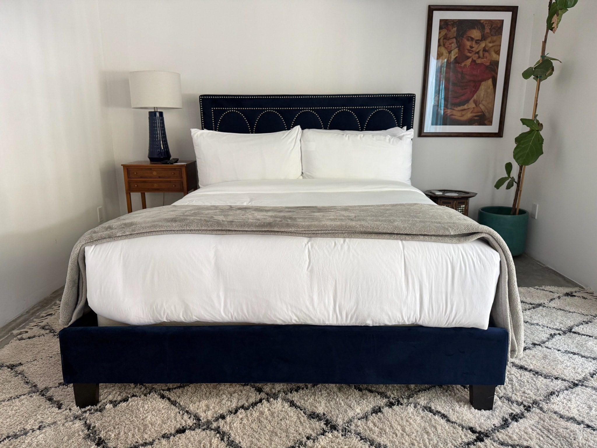 Modern bedroom with navy upholstered bed