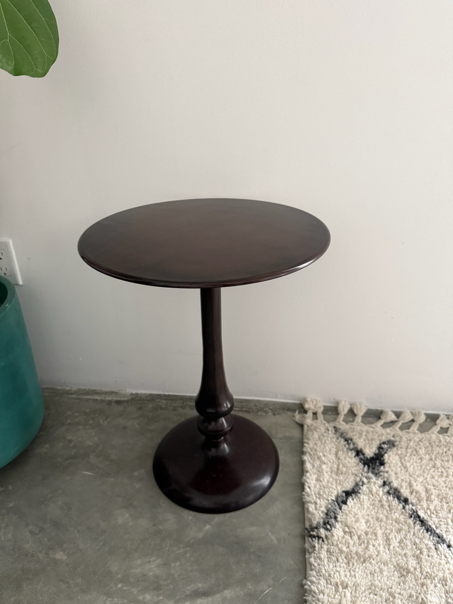 Black round pedestal side table