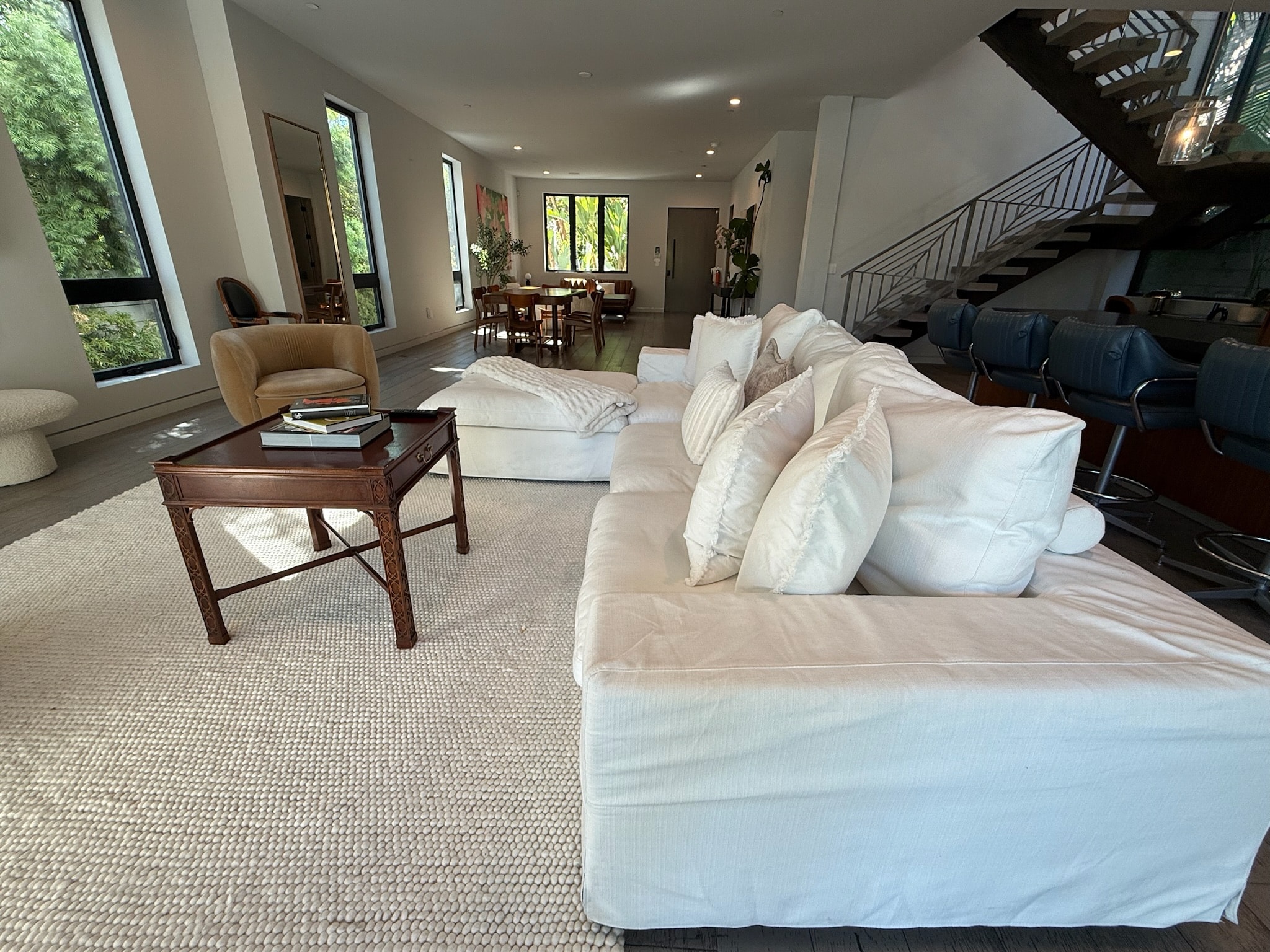Modern open-concept living room with cream sofa