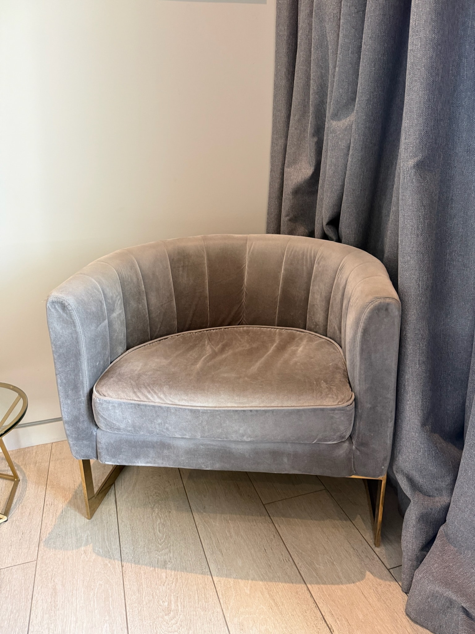 Gray velvet armchair with brass legs