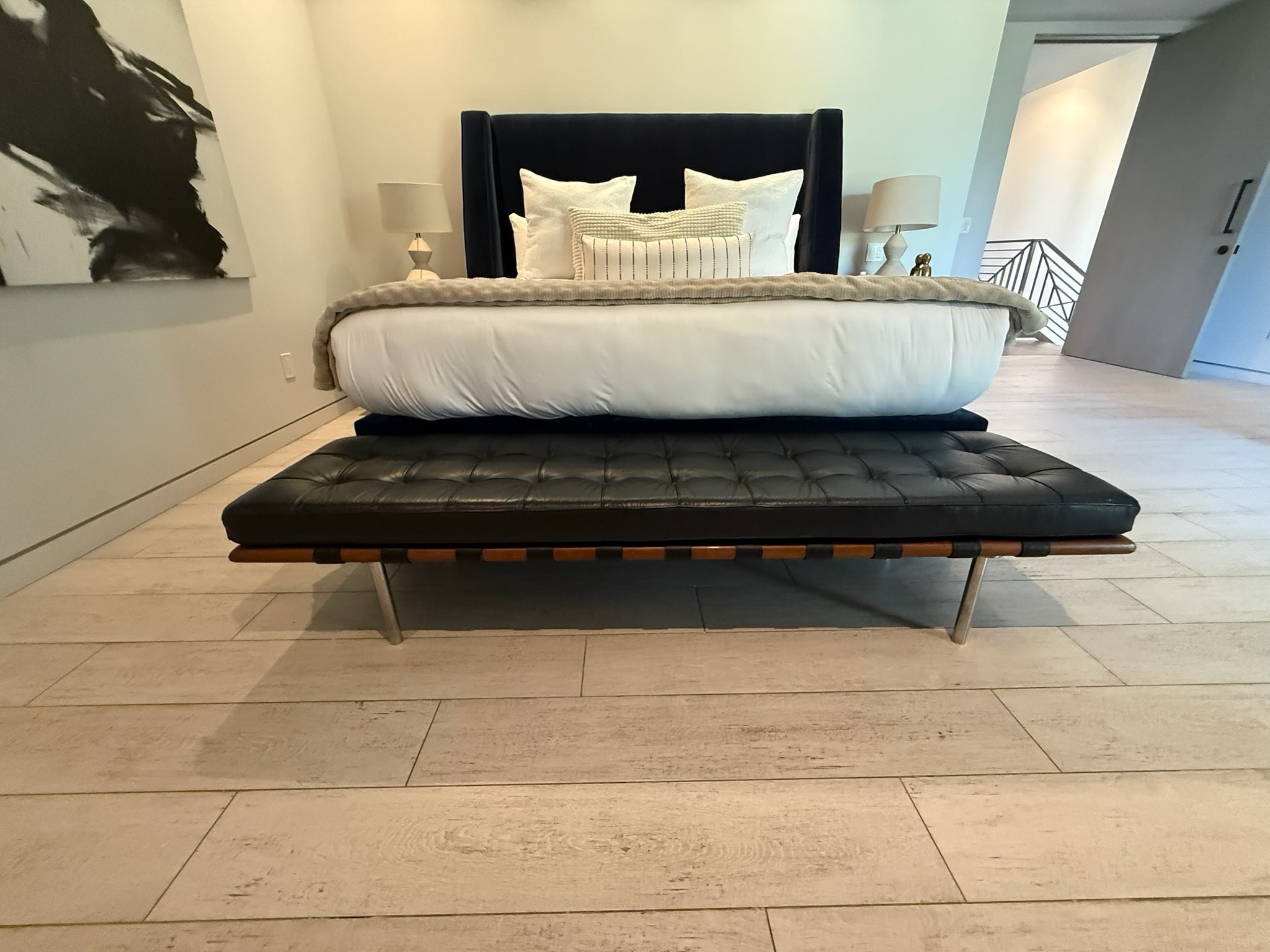 Modern bedroom with black bed and bench