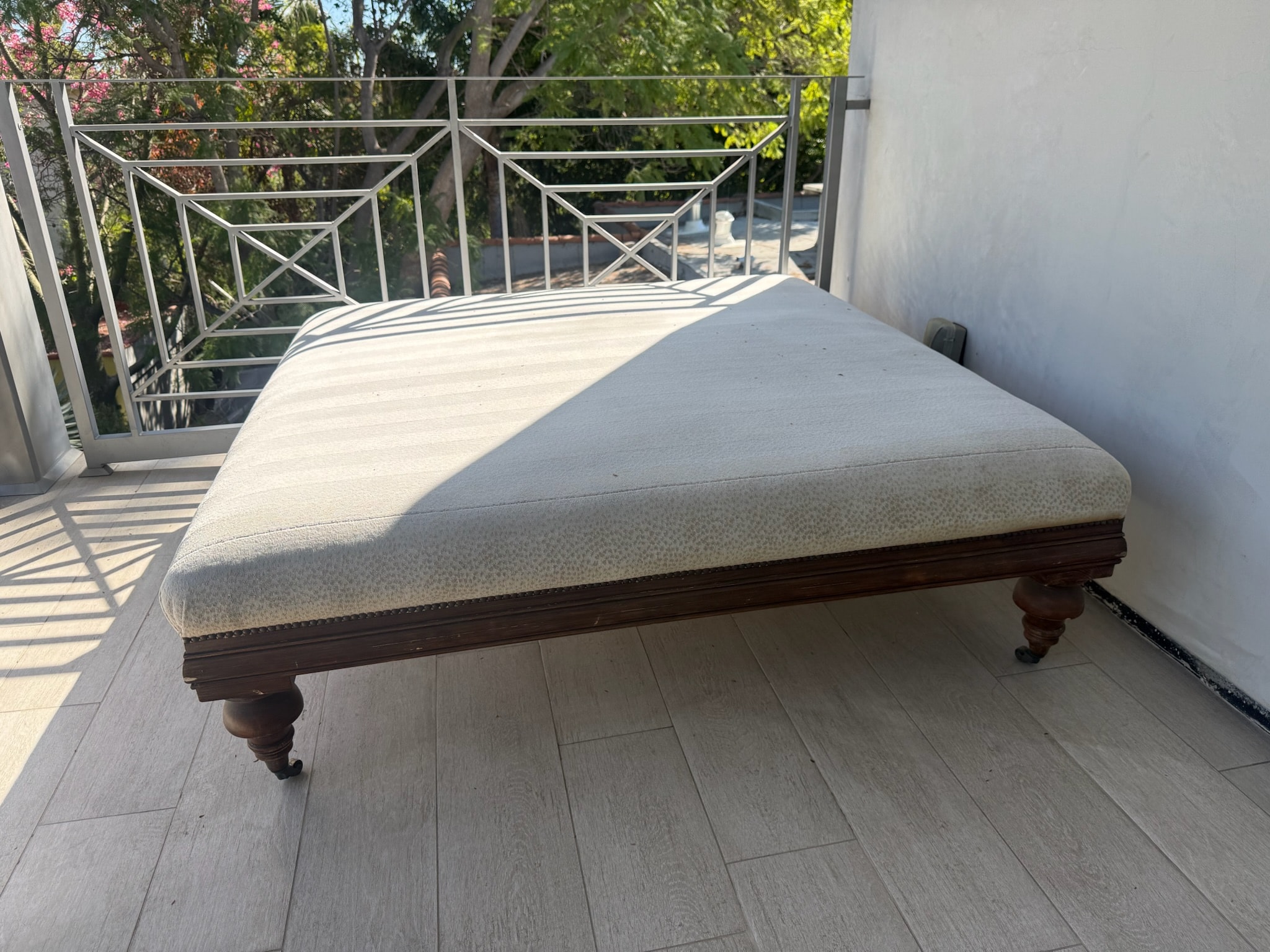 Upholstered bench on sunny terrace