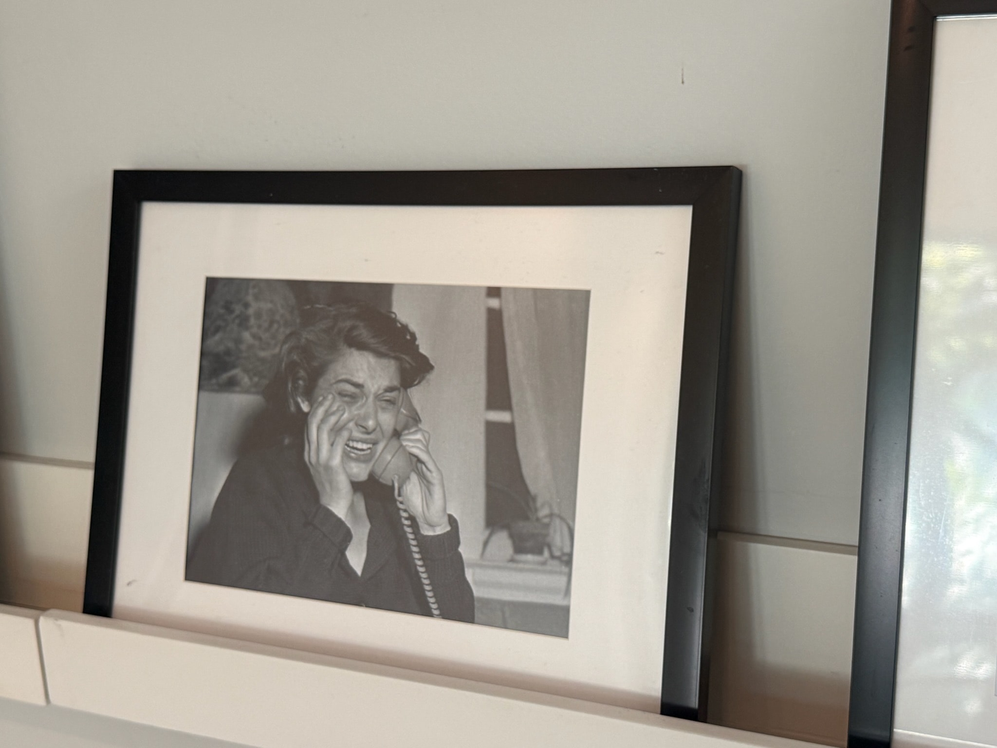 Woman laughing on vintage telephone black frame