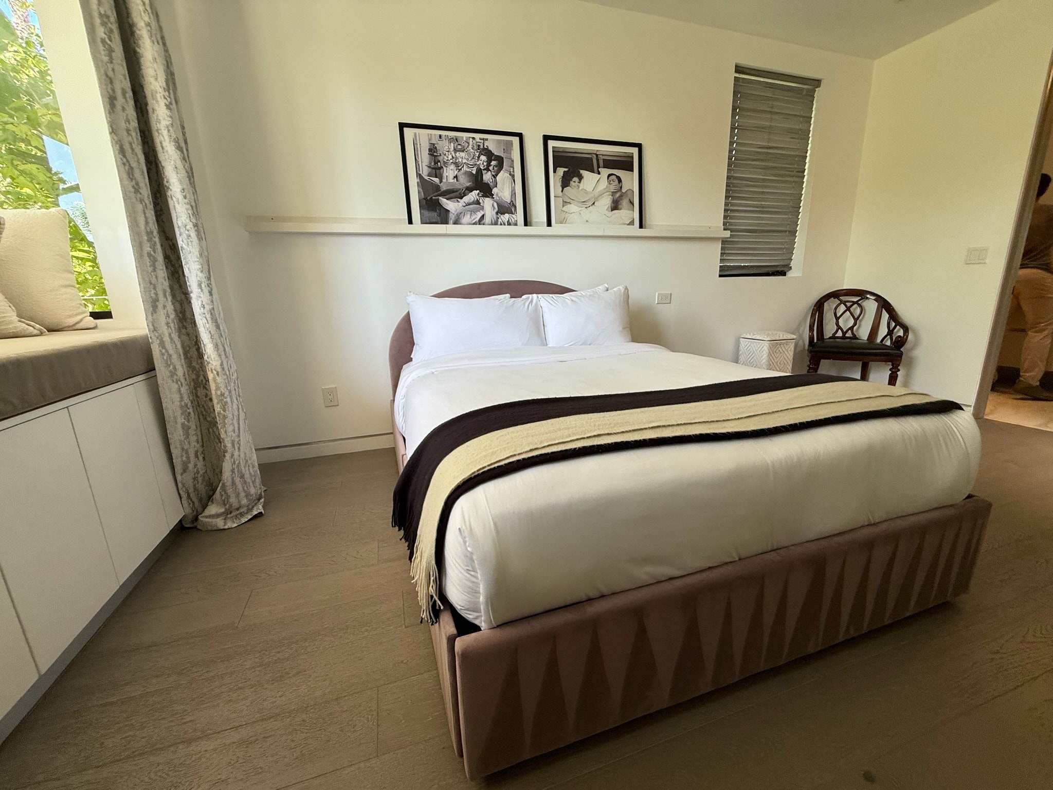 Modern bedroom with double beds and framed photos