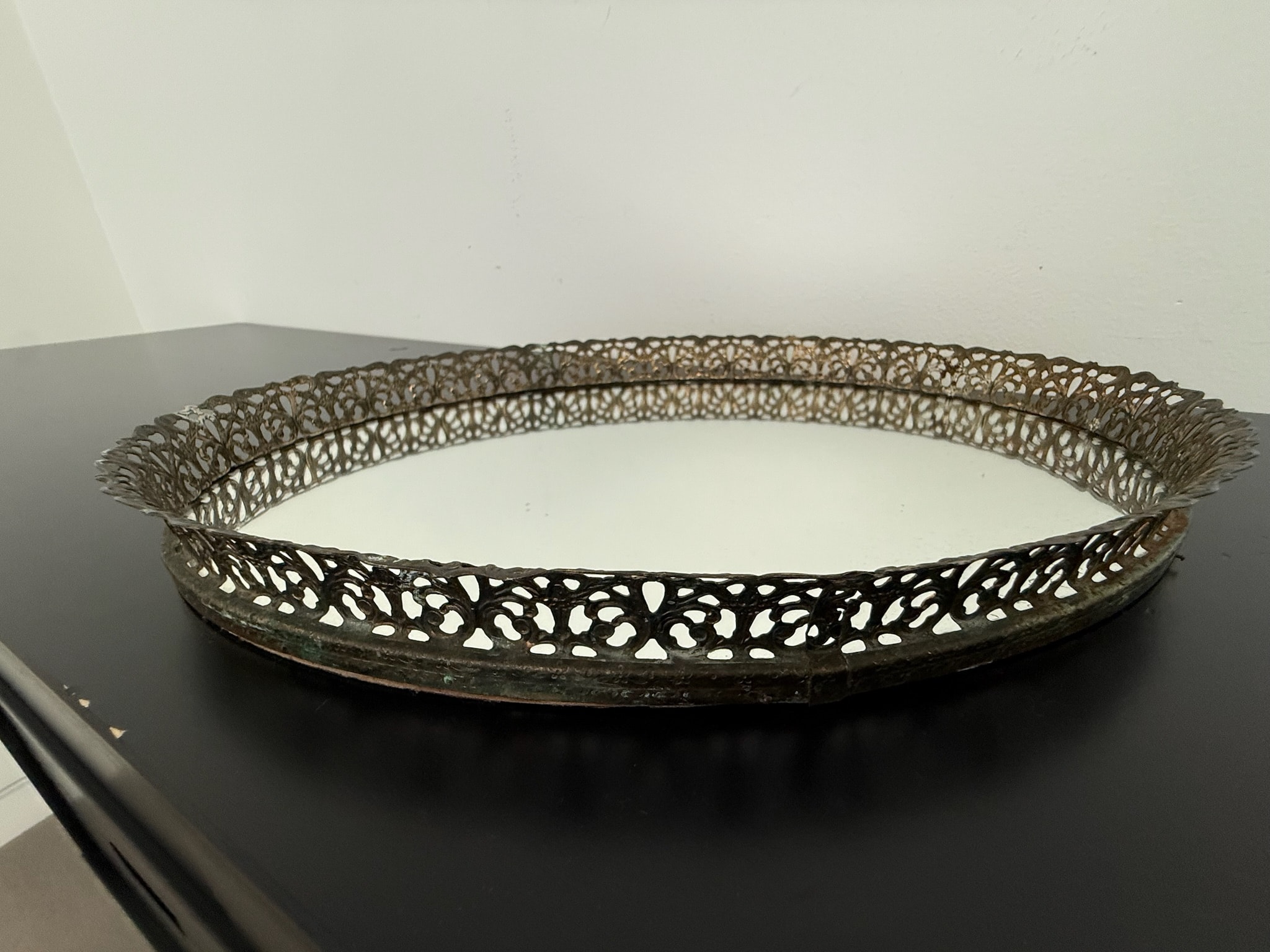 Ornate metal tray with mirror bottom