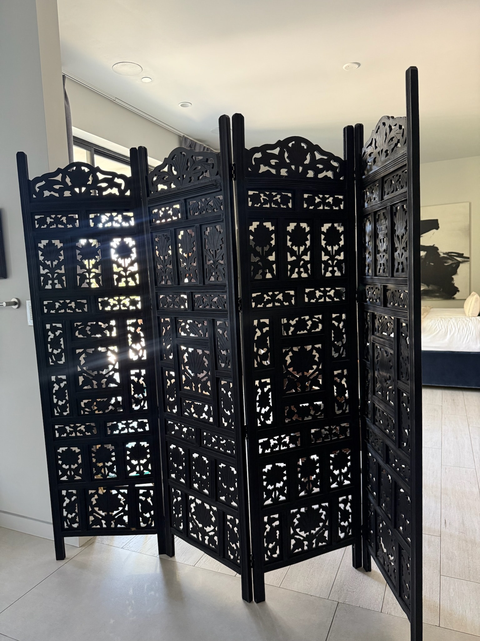 Ornate black folding room divider screen